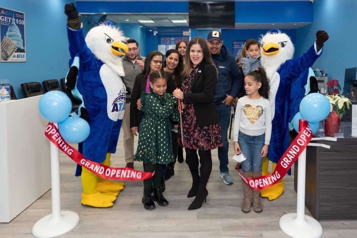 ATAX franchise grand opening — owners and family cutting the ribbon at the new storefront