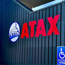ATAX bilingual storefront with eagle signage — a recognizable brand presence